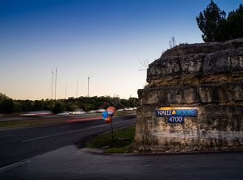 Property entrance sign illuminated at dusk
